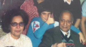 A photo from the 1970s of two older Indian grandparents and their grandson. 